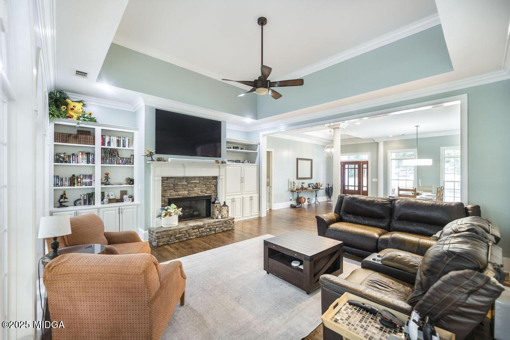 2489 Boxankle Road Forsyth, GA 31029 - Photo 12 of 68 a living room with furniture a flat screen tv and a fireplace