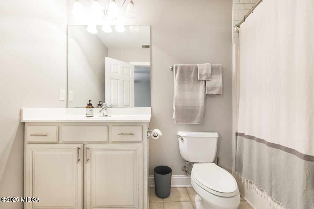 2489 Boxankle Road Forsyth, GA 31029 - Photo 37 of 68 a bathroom with a sink toilet vanity and shower