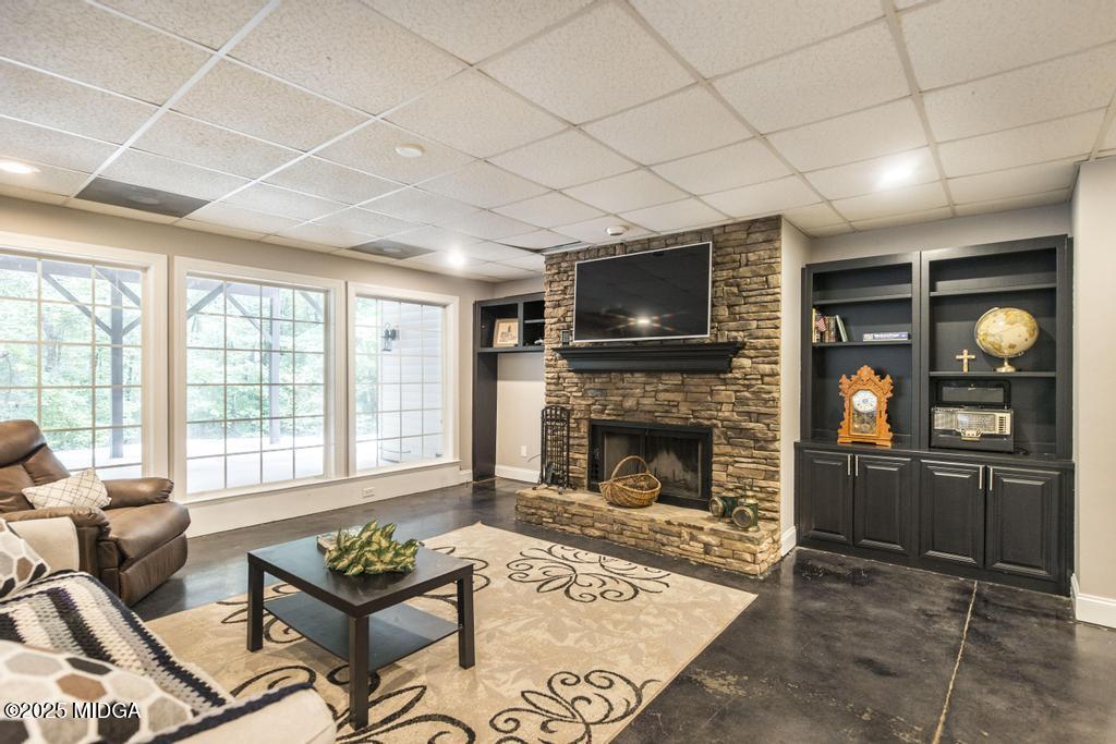 2489 Boxankle Road Forsyth, GA 31029 - Photo 41 of 68 a living room with furniture a flat screen tv and a fireplace