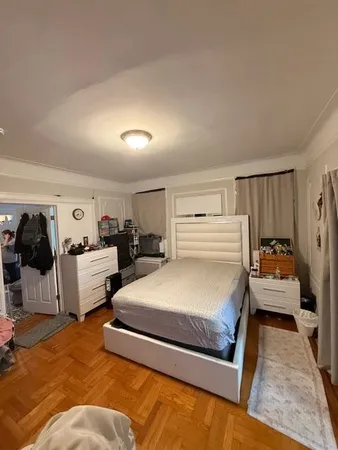 a spacious bedroom with a bed and a couch