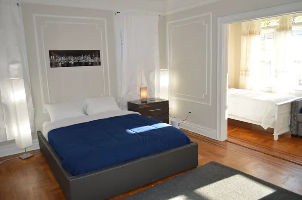 a living room with a bed furniture and a window