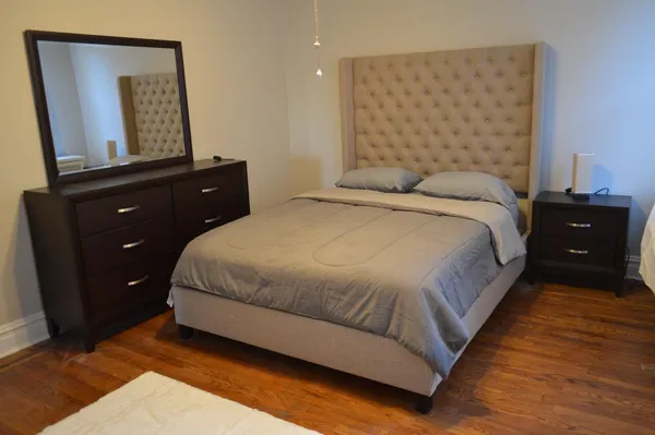 a bedroom with a bed and a night stand