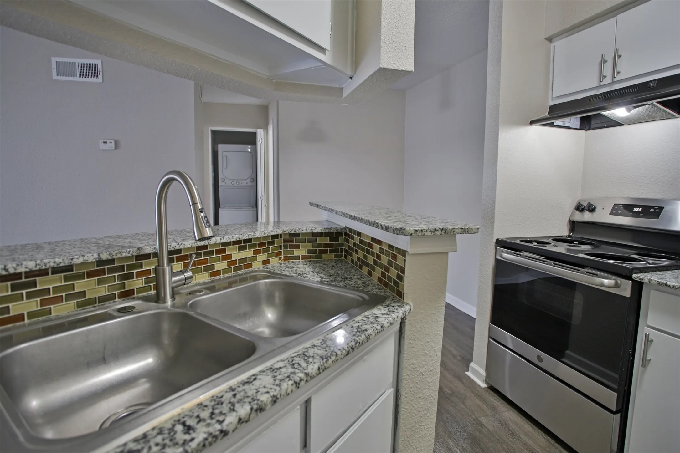 2700 South Dairy Ashford Road, Unit 610D Houston, TX 77082 - Photo 5 of 15 a close view of a sink and a stove in a kitchen