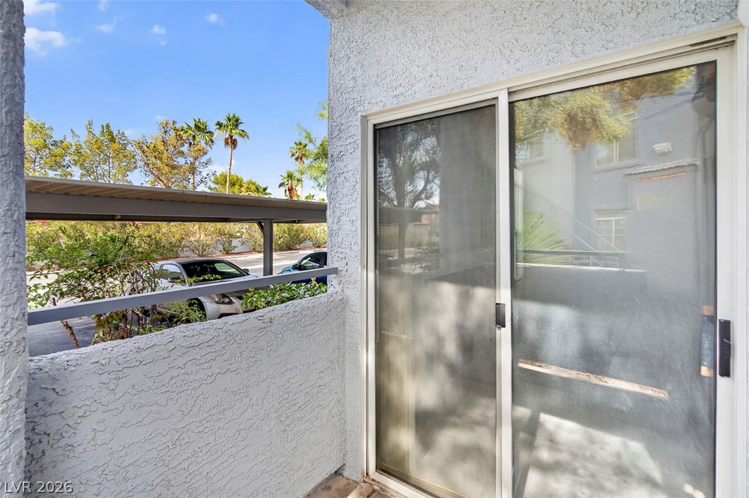 2201 Ramsgate Drive, Unit 1011 Henderson, NV 89074 - Photo 31 of 40 A private patio with sliding doors offers seamless indoor-outdoor living and convenient covered parking.