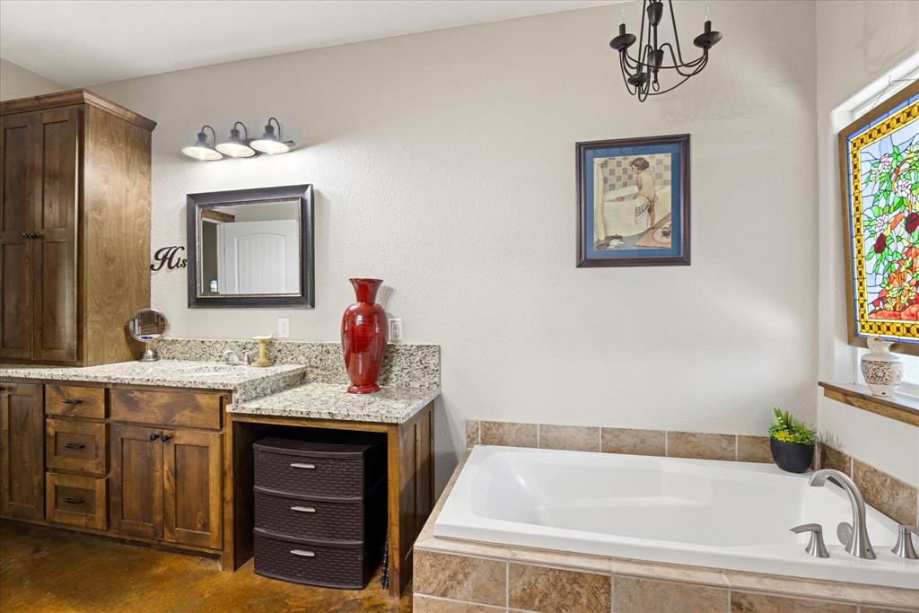 3761 County Road 149 Bluff Dale, TX 76433 - Photo 16 of 37 a bathroom with a tub sink and mirror