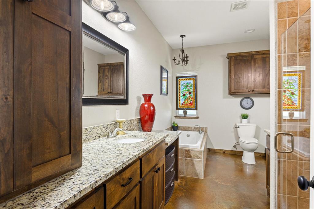 3761 County Road 149 Bluff Dale, TX 76433 - Photo 17 of 37 a spacious bathroom with a granite countertop sink a mirror and shower