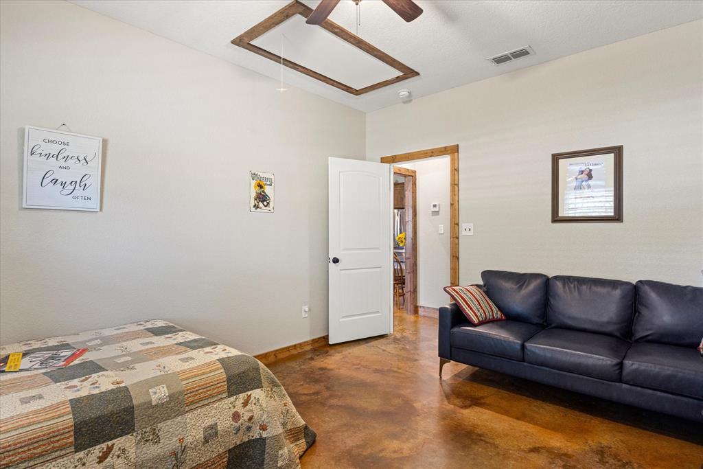3761 County Road 149 Bluff Dale, TX 76433 - Photo 20 of 37 a bedroom with a bed couch and painting on the wall