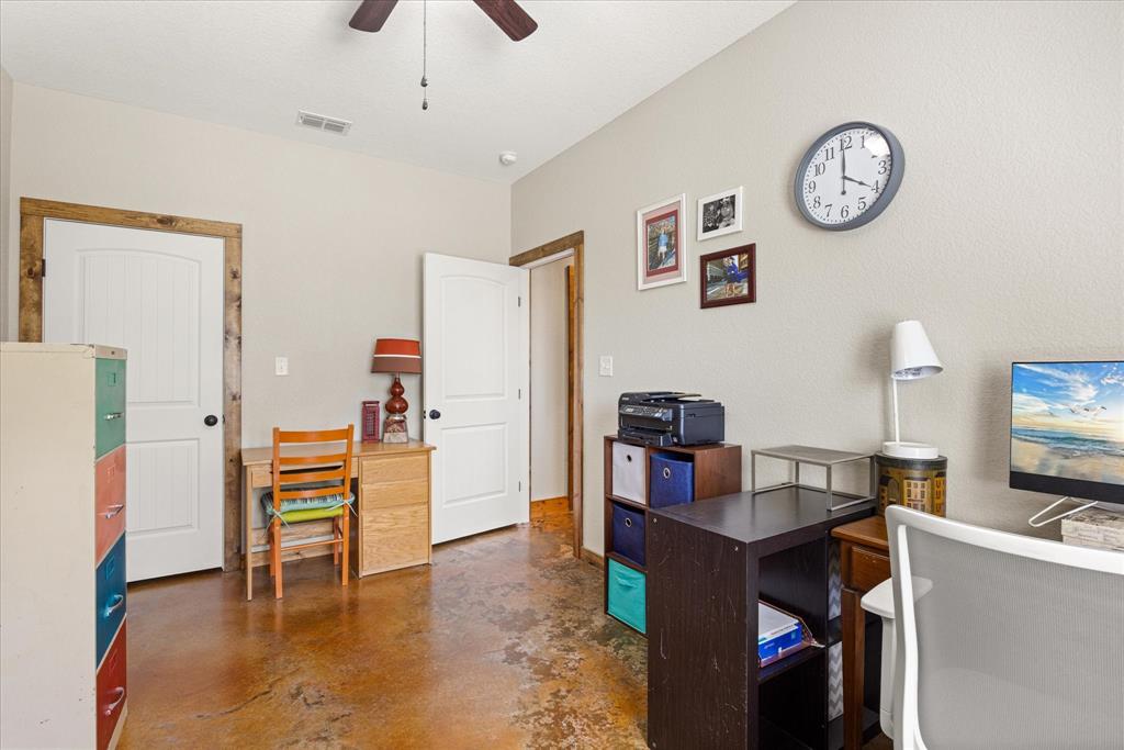 3761 County Road 149 Bluff Dale, TX 76433 - Photo 22 of 37 a view of a workspace with furniture and a kitchen