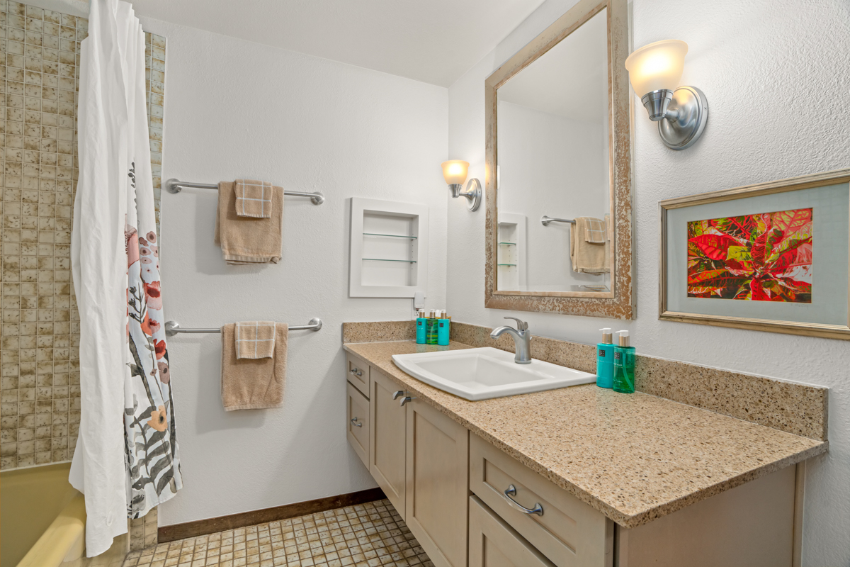 1870 Hoone Road, Unit 602 Koloa, HI 96756 - Photo 20 of 26 a bathroom with a granite countertop sink and a mirror