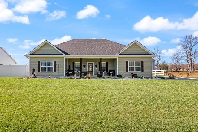 a front view of a house with a garden and porch