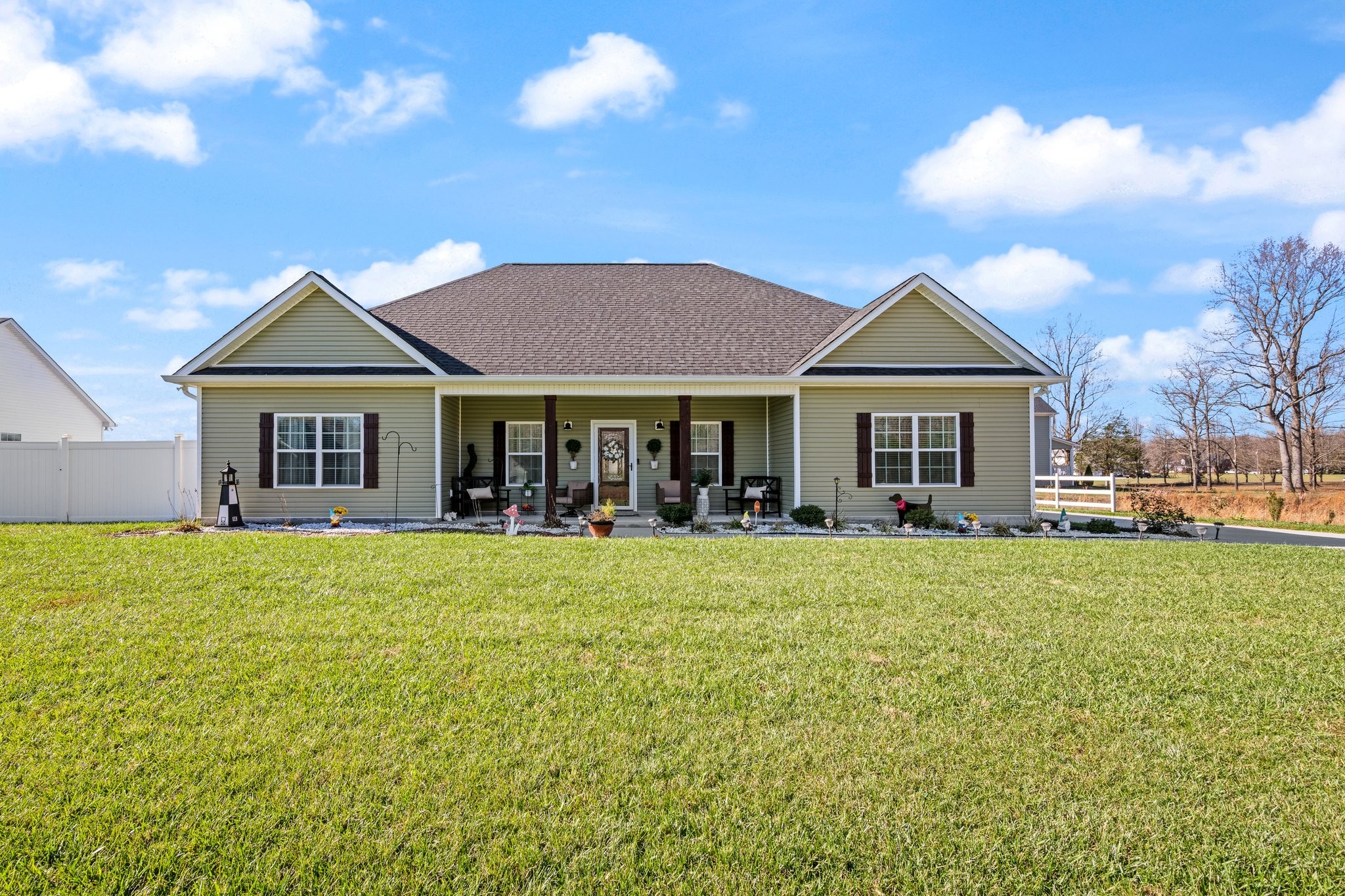 a front view of a house with a garden and porch