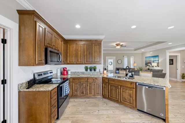 a kitchen with a sink a stove and cabinets