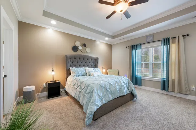 a spacious bedroom with a bed and a large window