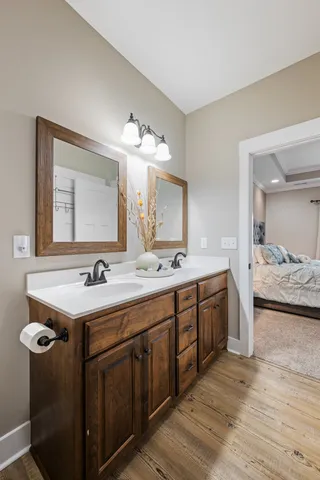a bathroom with a double vanity sink and a mirror