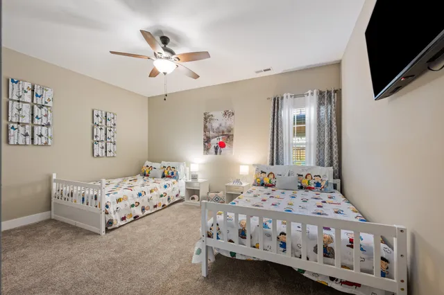 a bedroom with bed and a chandelier