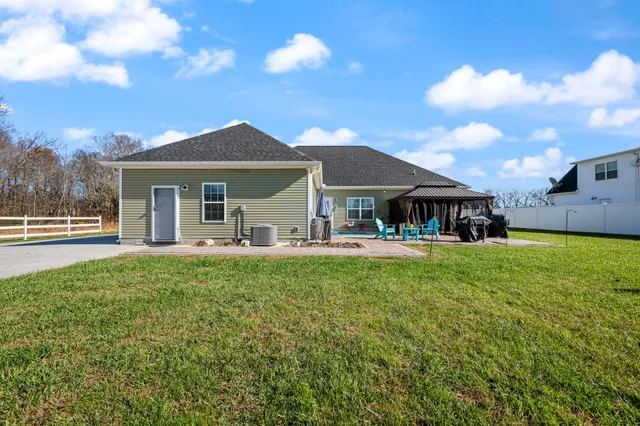 a front view of a house with yard porch and outdoor seating