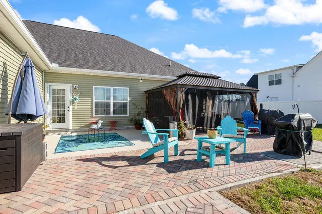 a view of a dinning tables and chairs in a patio