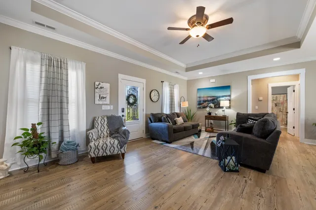 a living room with furniture and a chandelier