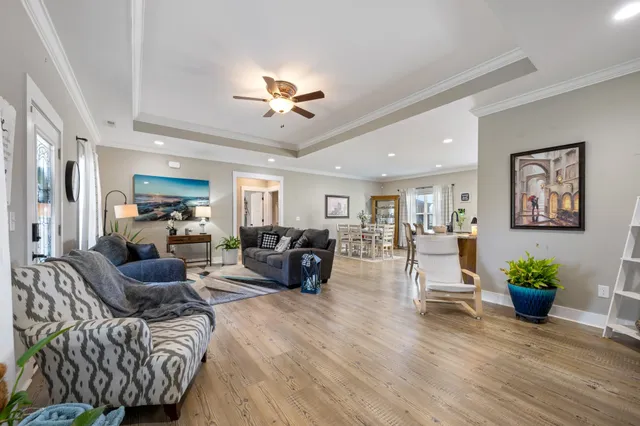 a living room with furniture potted plant and a chandelier