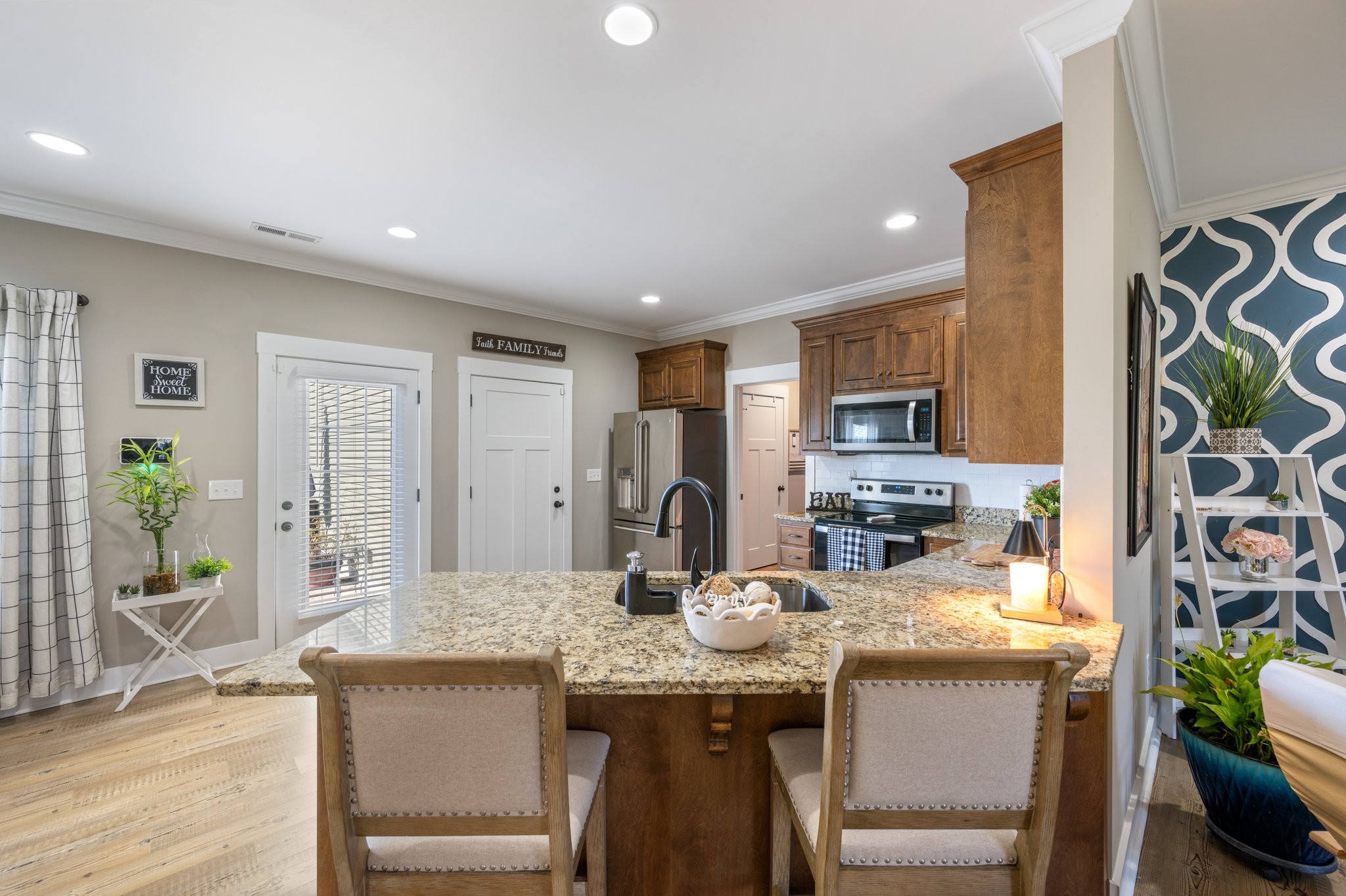 1357 Norton Road Manchester, TN 37355 - Photo 9 of 29 a kitchen with granite countertop a table chairs stove and cabinets