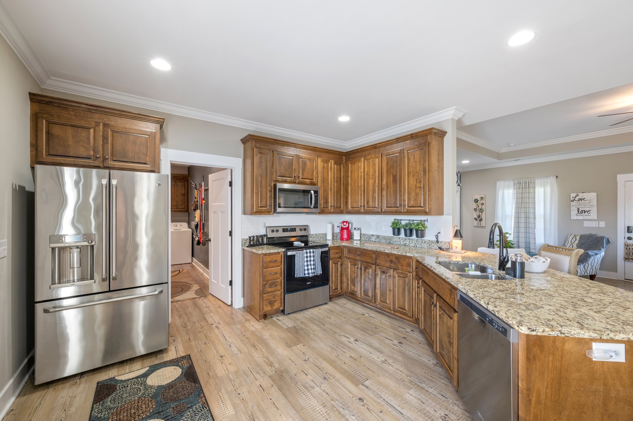 1357 Norton Road Manchester, TN 37355 - Photo 10 of 29 a kitchen with stainless steel appliances granite countertop a refrigerator a sink dishwasher a stove and white countertops with wooden floor