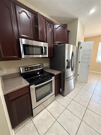a kitchen with stainless steel appliances and cabinets