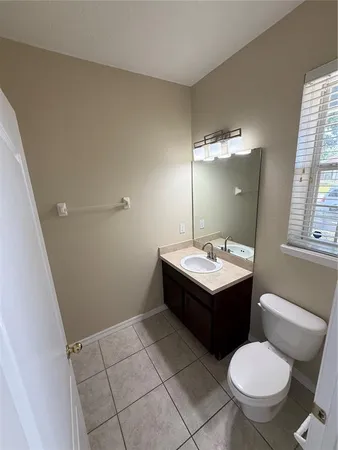 a bathroom with a sink toilet and mirror