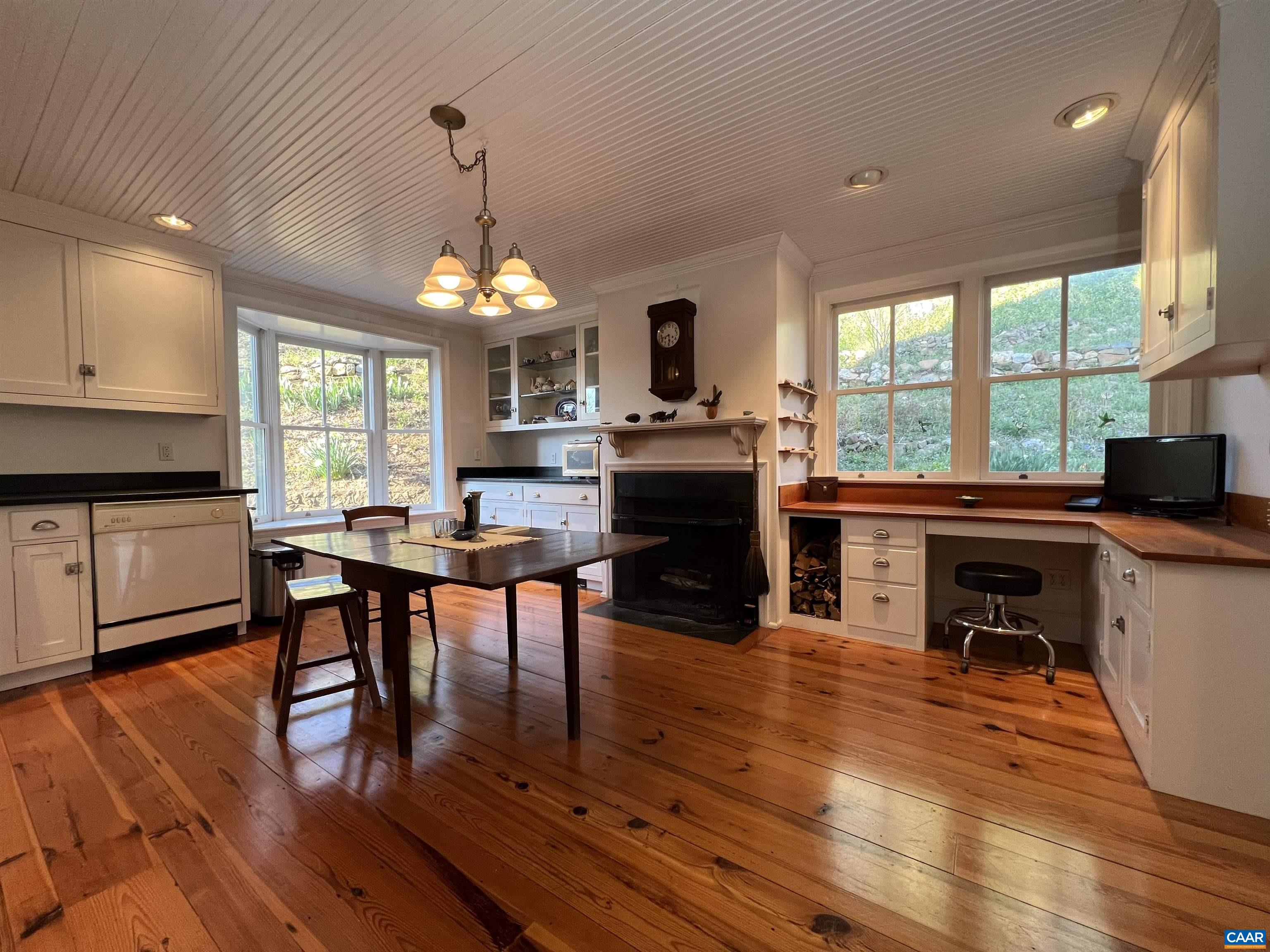 6742 Plank Road Charlottesville, VA 22903 - Photo 14 of 61 a dining room with wooden floor a chandelier a wooden table and chairs