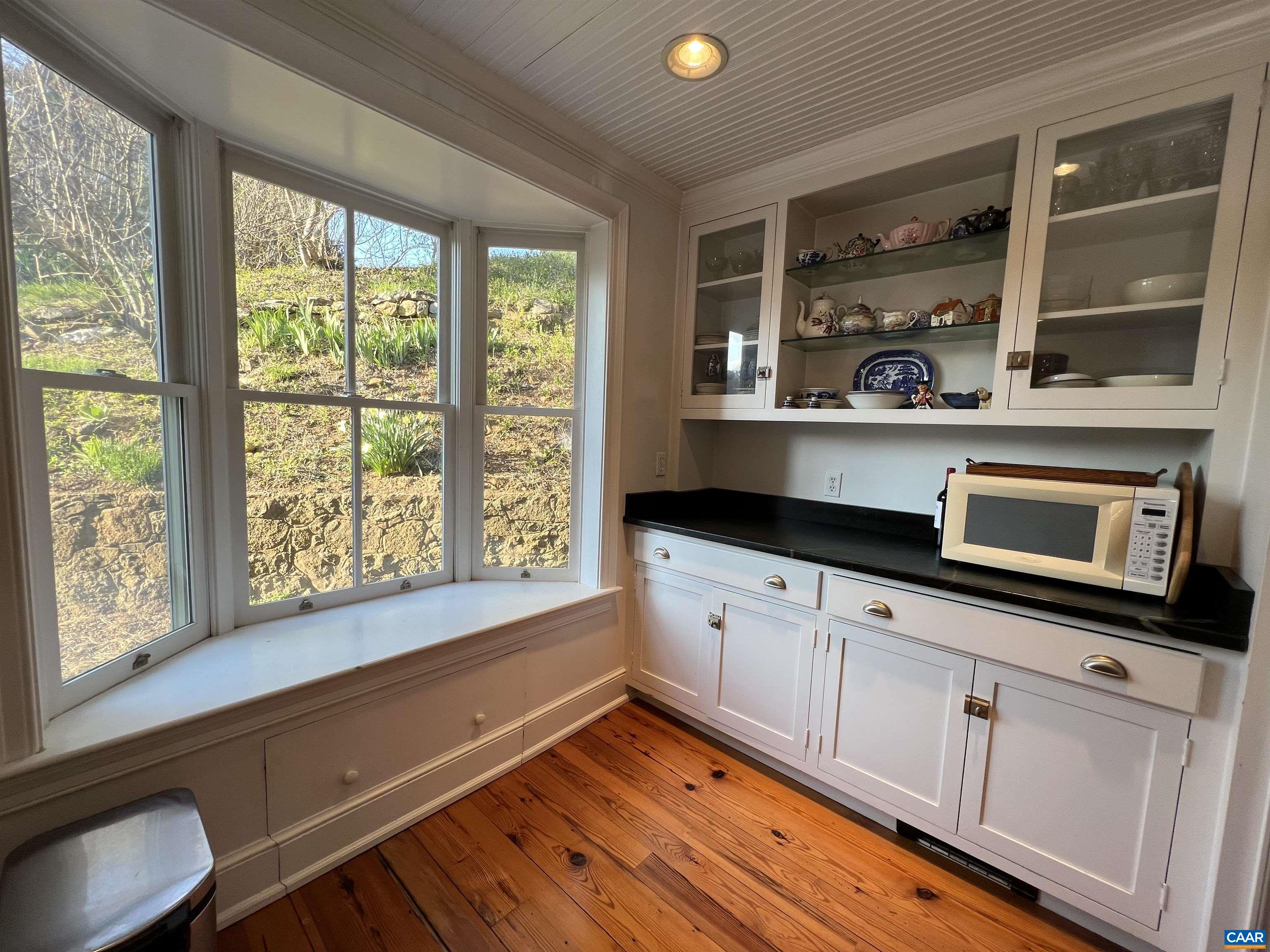 6742 Plank Road Charlottesville, VA 22903 - Photo 18 of 61 a kitchen with stainless steel appliances wooden cabinets and a large window