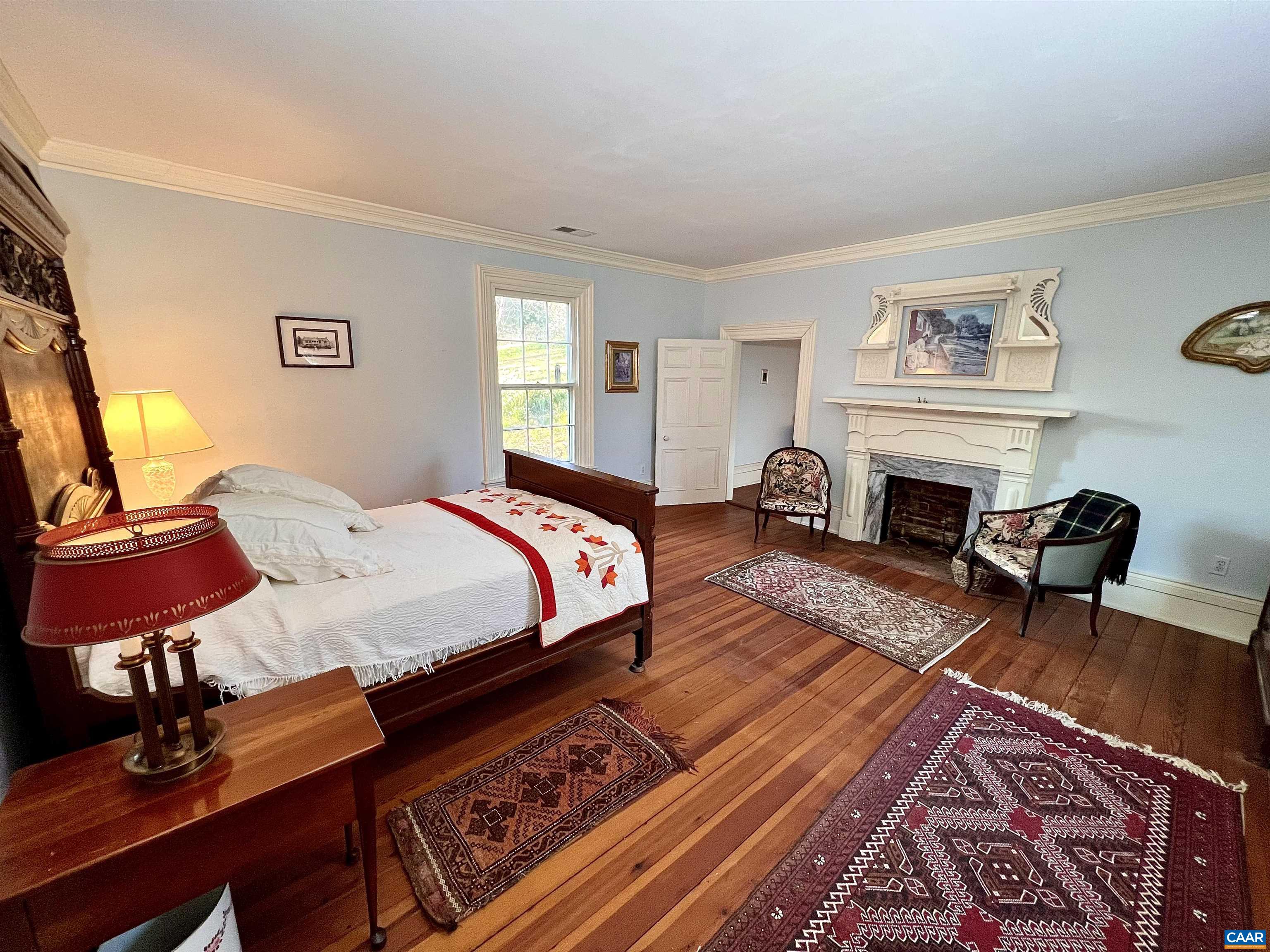 6742 Plank Road Charlottesville, VA 22903 - Photo 31 of 61 a spacious bedroom with a bed a dresser and chair