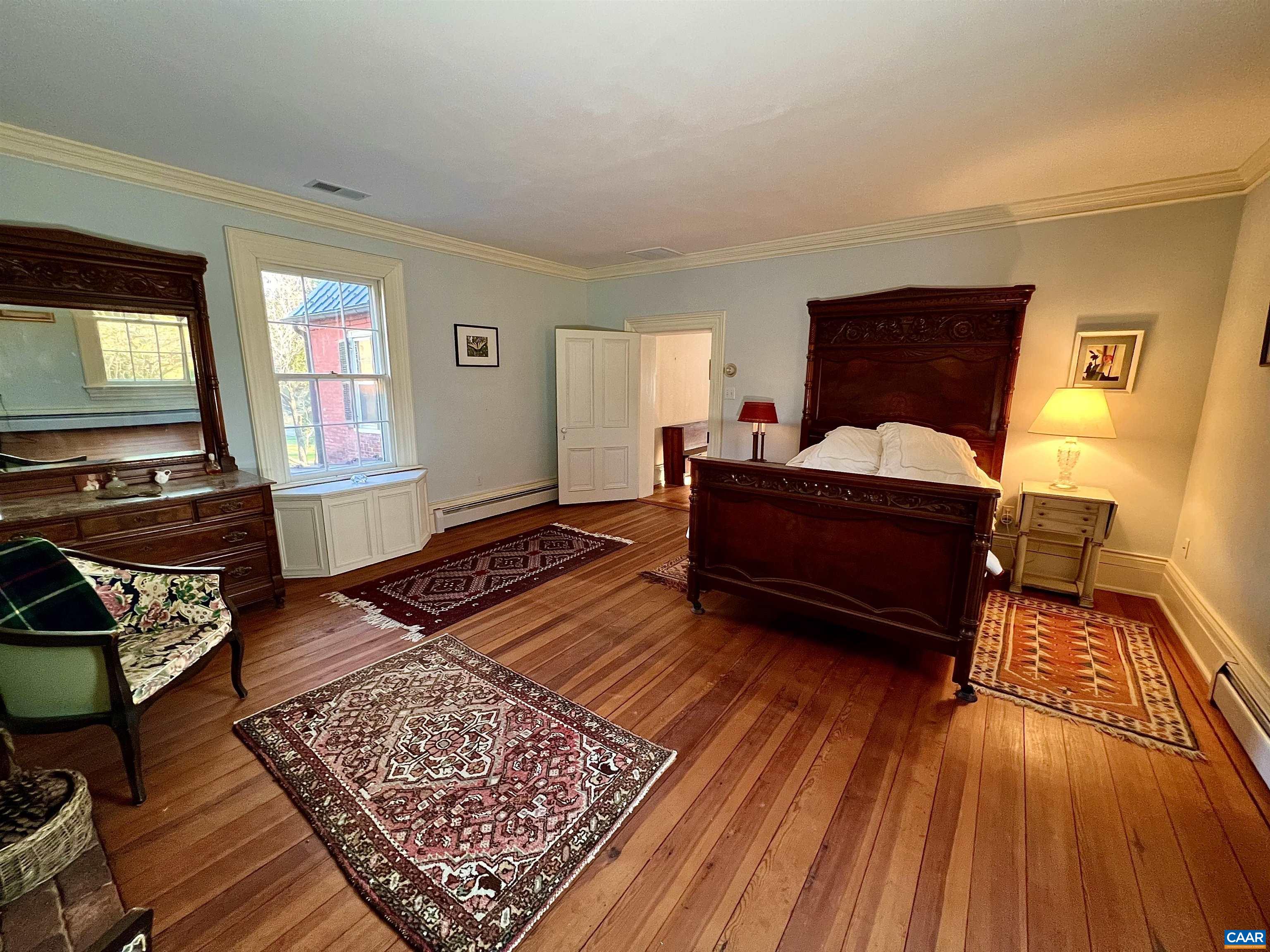 6742 Plank Road Charlottesville, VA 22903 - Photo 32 of 61 a living room with furniture and a wooden floor