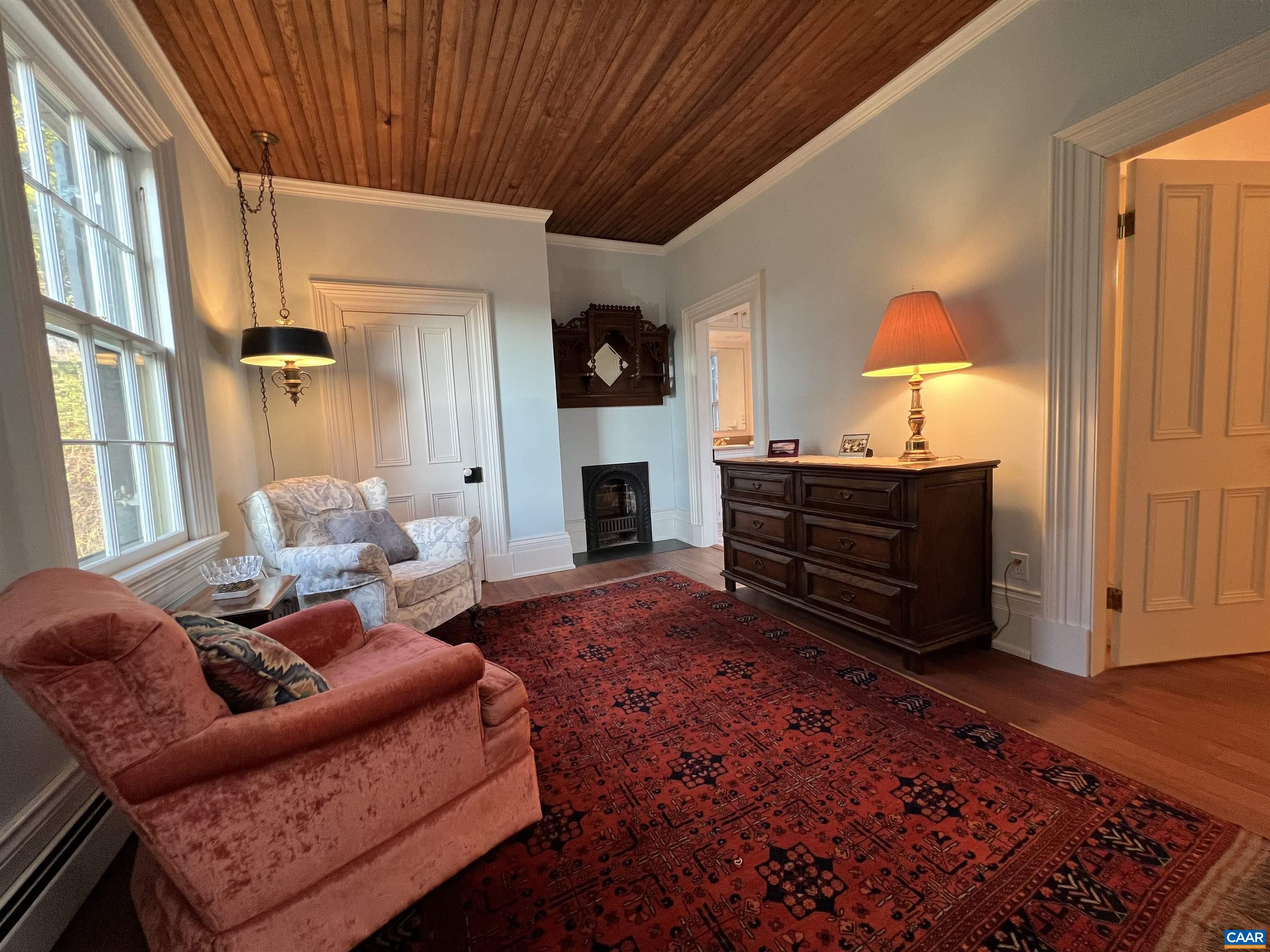 6742 Plank Road Charlottesville, VA 22903 - Photo 34 of 61 a living room with furniture a flat screen tv and a fireplace