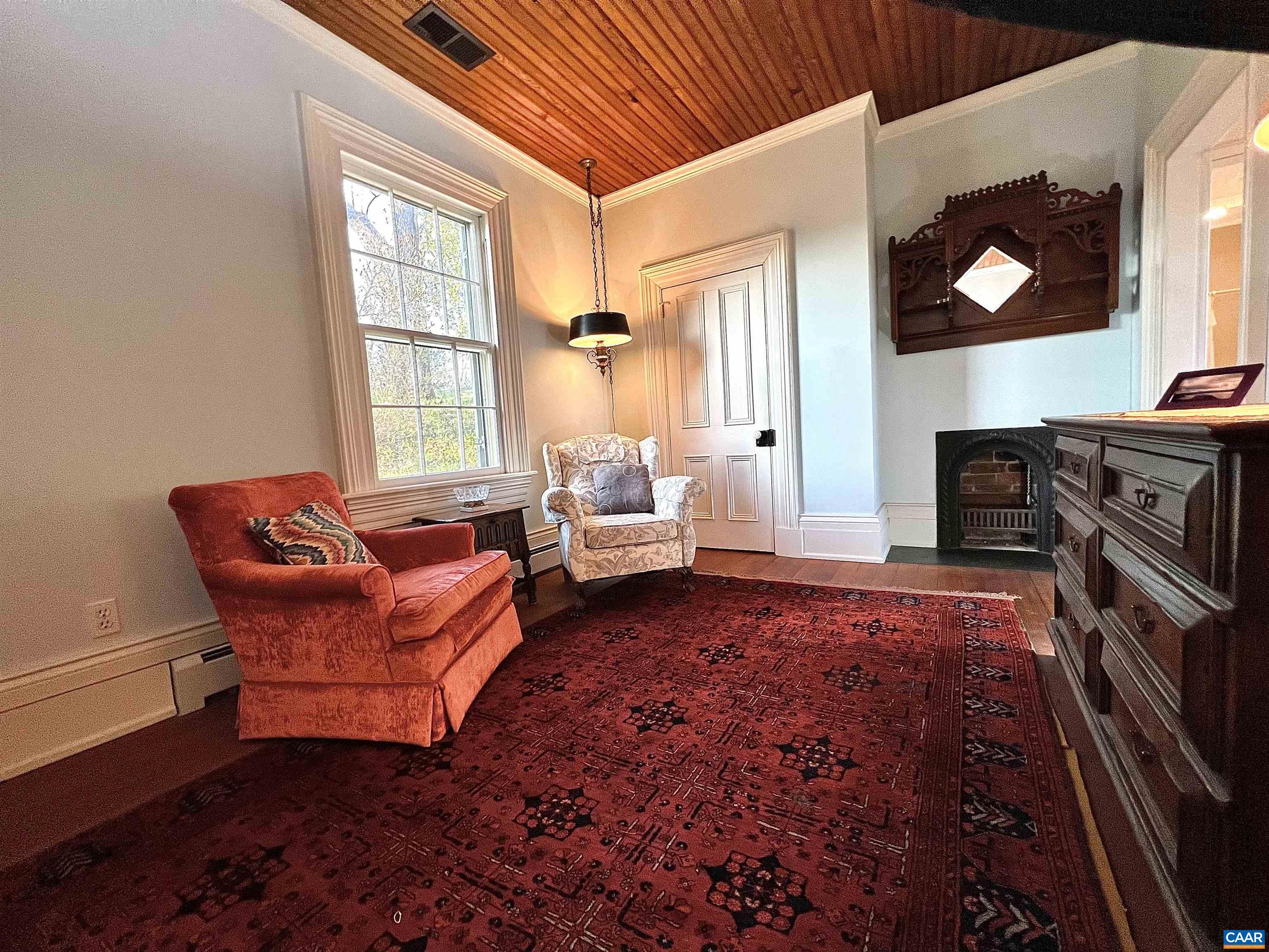 6742 Plank Road Charlottesville, VA 22903 - Photo 35 of 61 a living room with furniture a flat screen tv and a fireplace