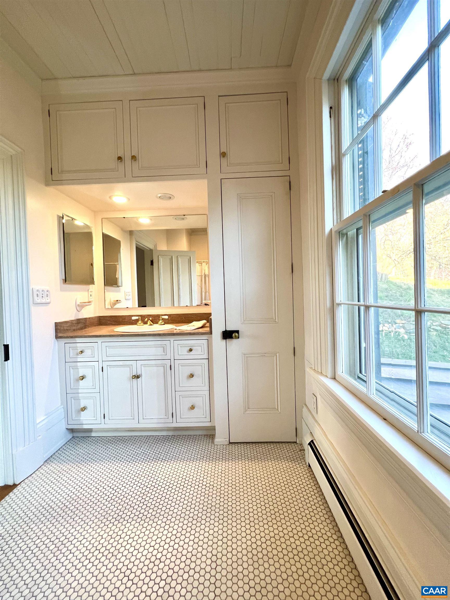6742 Plank Road Charlottesville, VA 22903 - Photo 37 of 61 a bathroom with a granite countertop sink mirror and next to a window