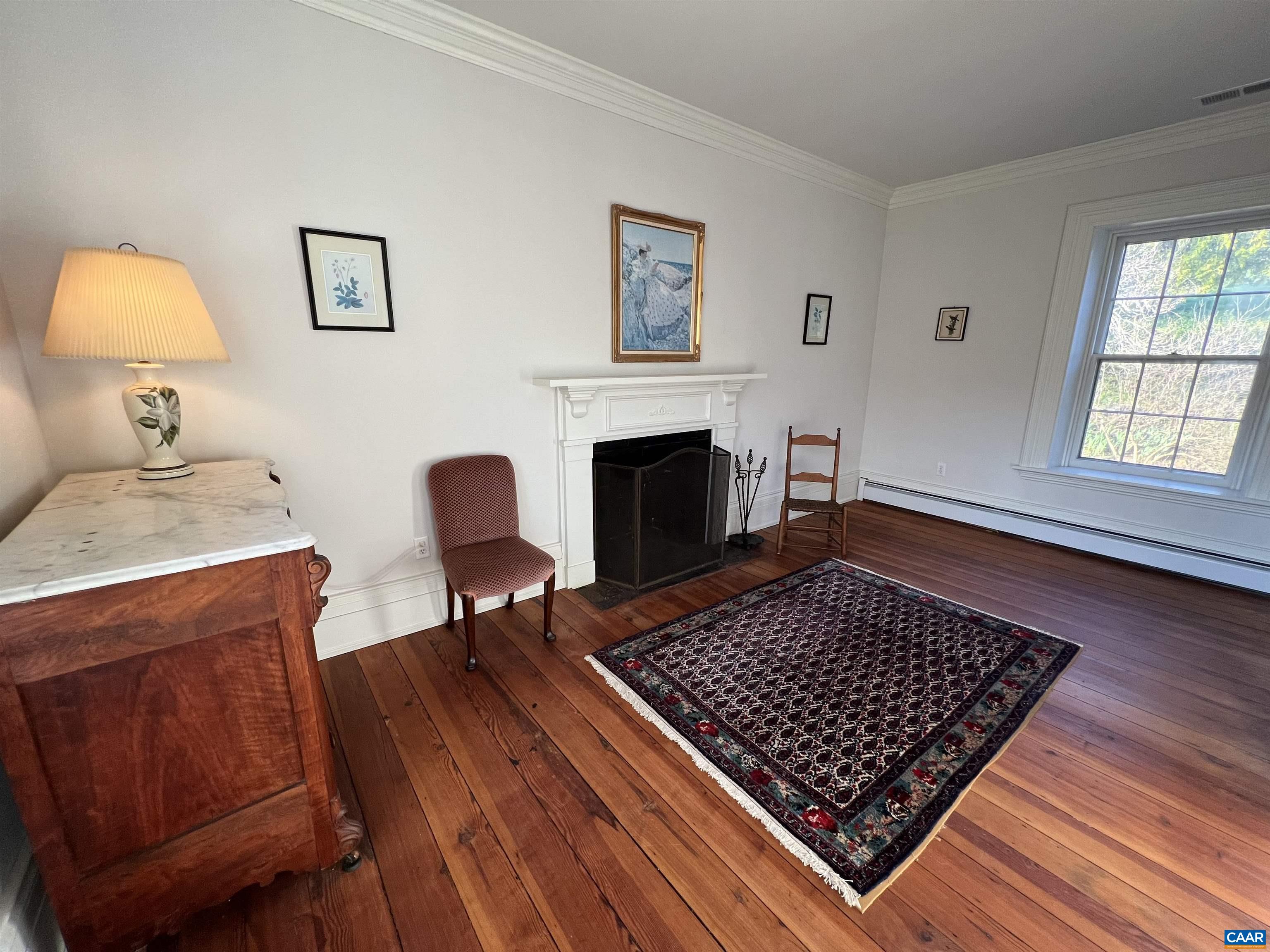 6742 Plank Road Charlottesville, VA 22903 - Photo 38 of 61 a living room with furniture and a fireplace