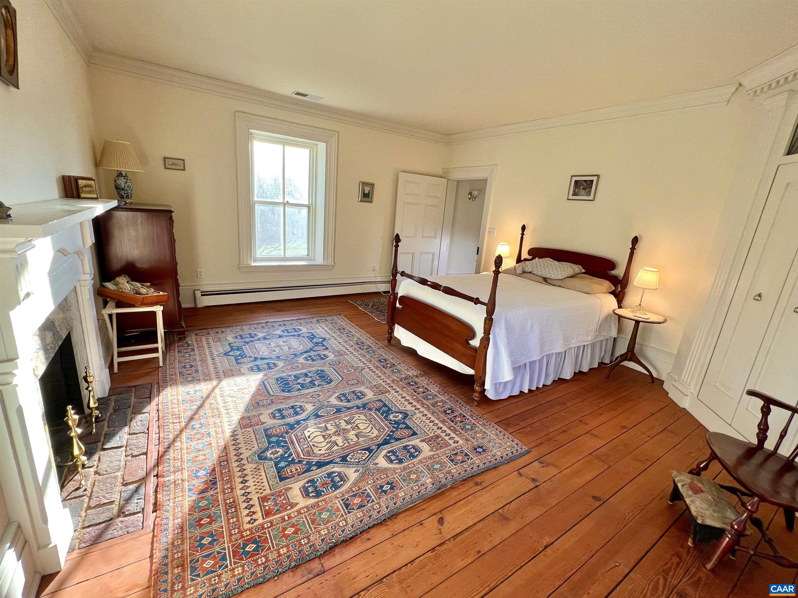 6742 Plank Road Charlottesville, VA 22903 - Photo 42 of 61 a bedroom with a bed and wooden floor