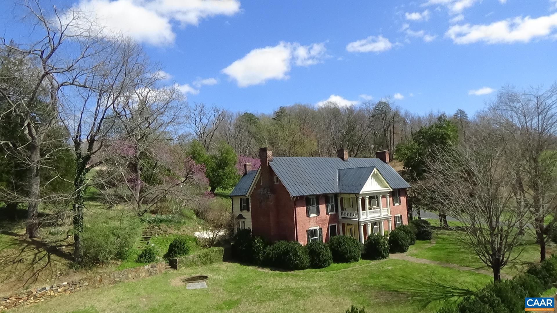 6742 Plank Road Charlottesville, VA 22903 - Photo 5 of 61 a view of a big house with a big yard and large trees