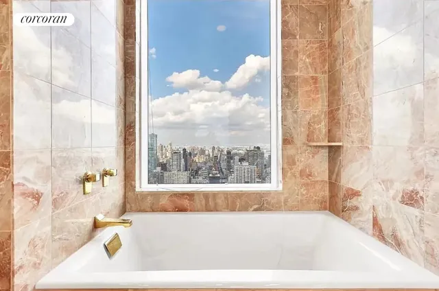 a bathroom with a granite countertop sink and a large mirror