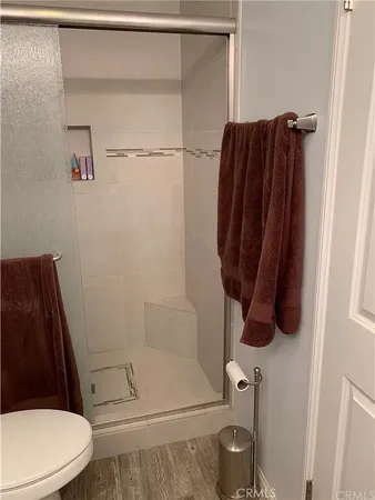 a bathroom with a shower and toilet