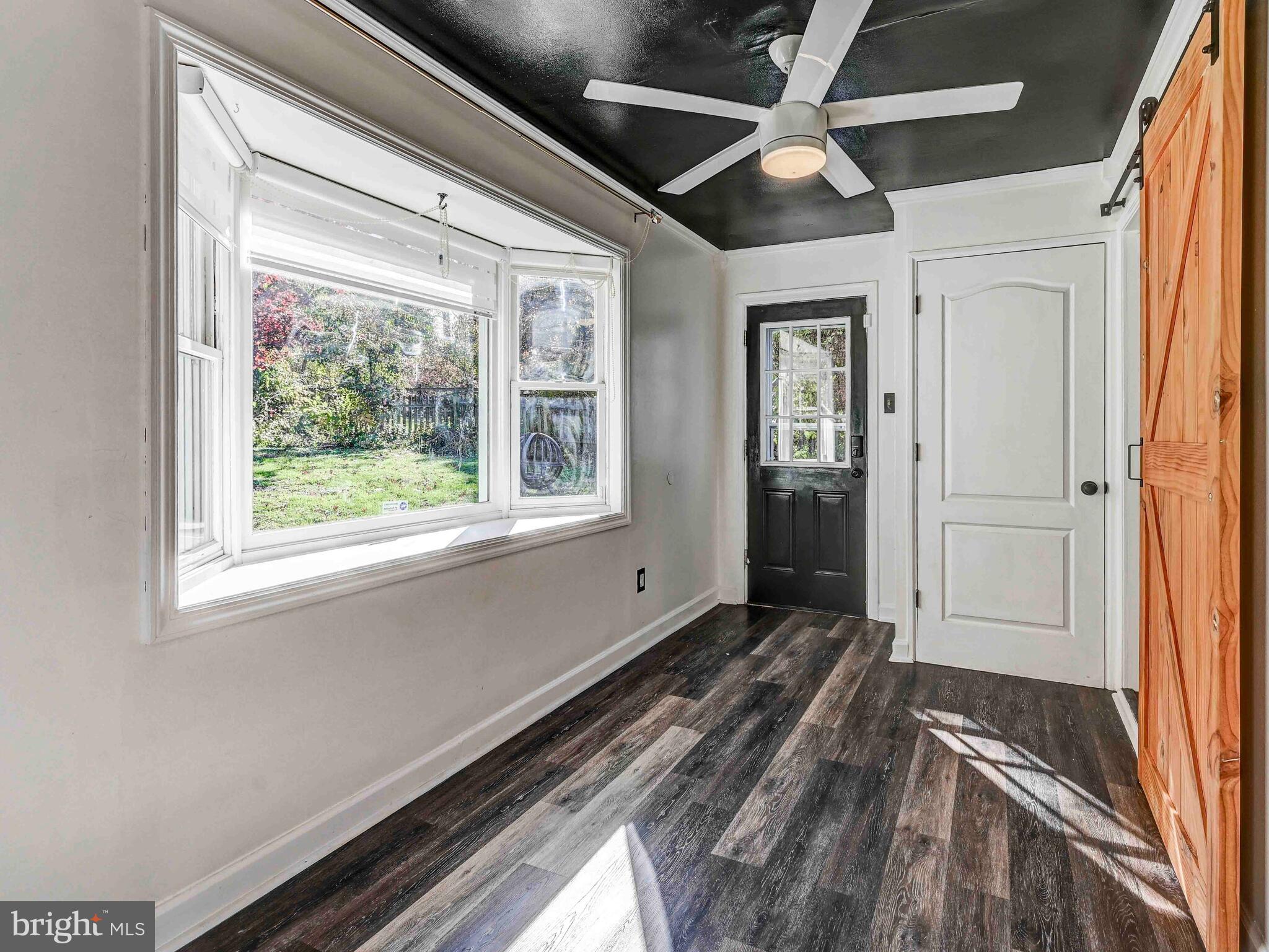 913 Adana Road Baltimore, MD 21208 - Photo 11 of 26 a view of an empty room with wooden floor and a window