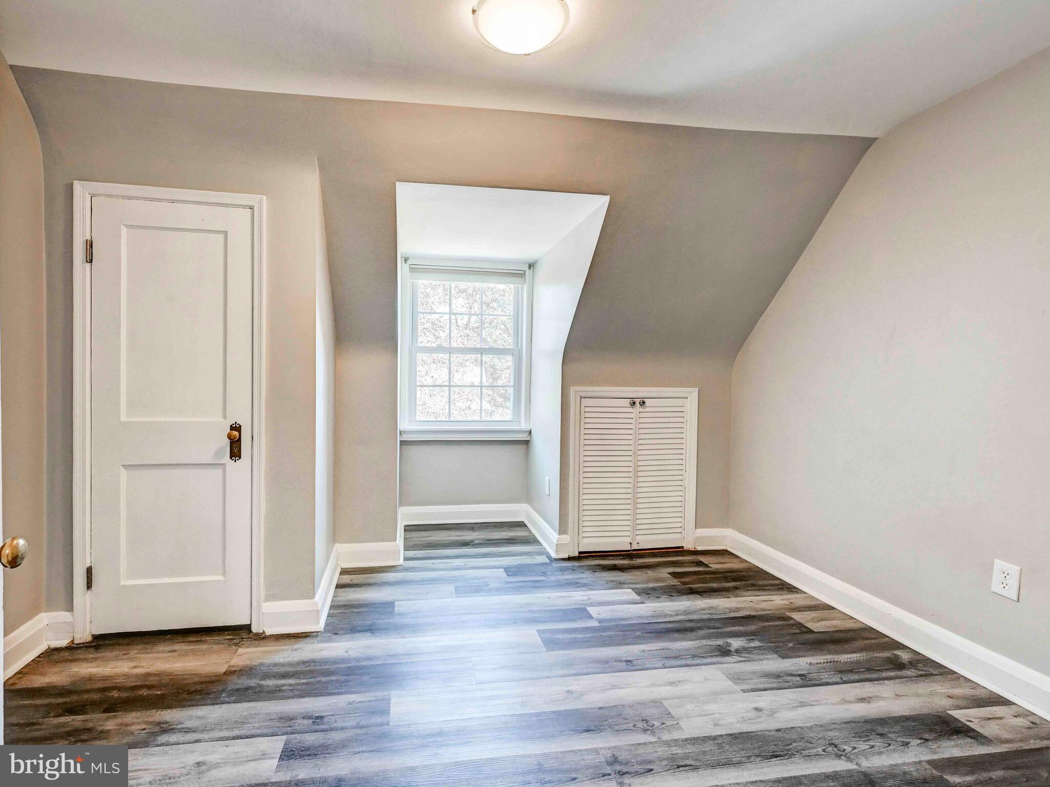 913 Adana Road Baltimore, MD 21208 - Photo 14 of 26 an empty room with wooden floor & windows