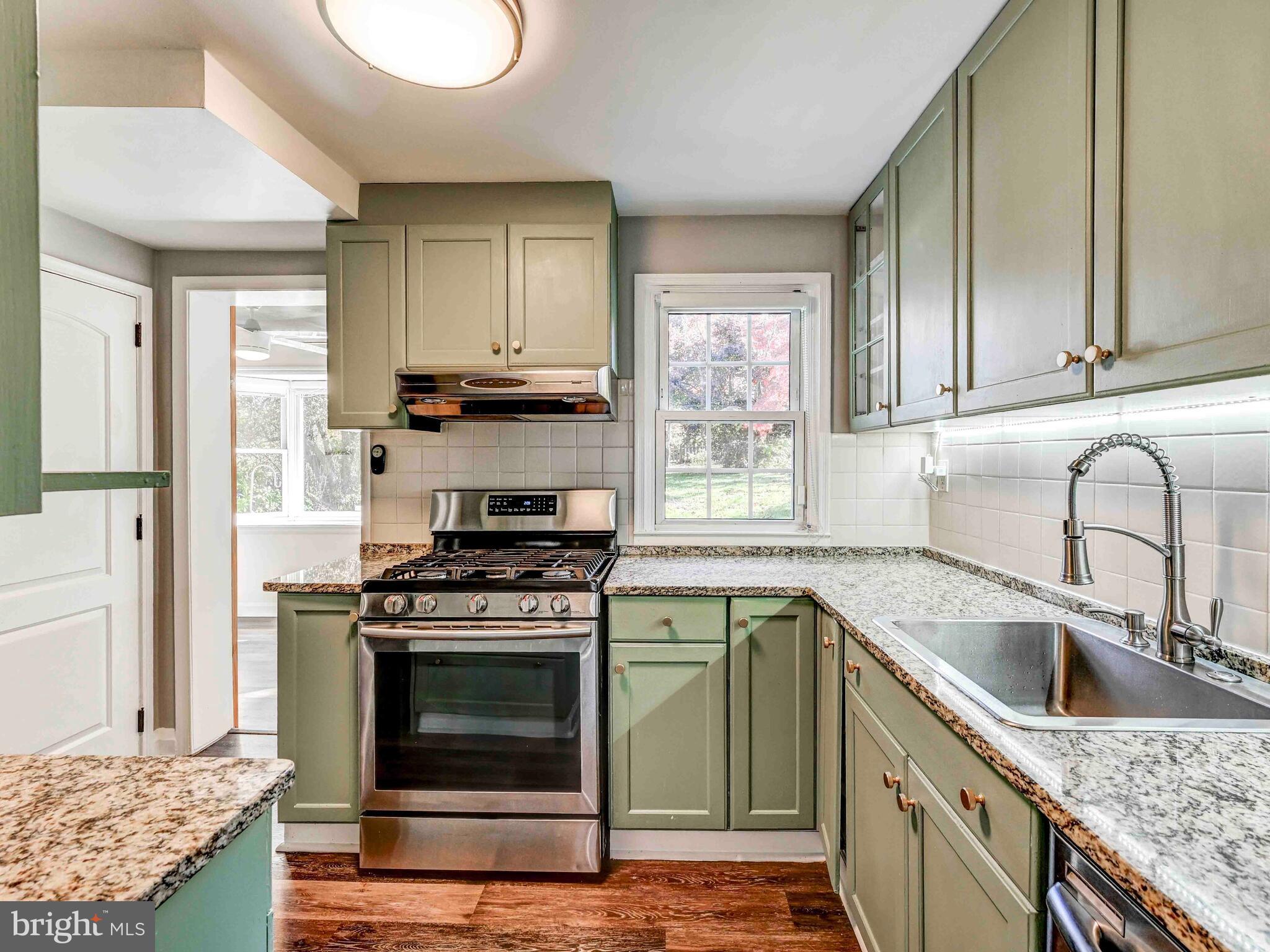 913 Adana Road Baltimore, MD 21208 - Photo 5 of 26 a kitchen with granite countertop a sink stainless steel appliances and cabinets