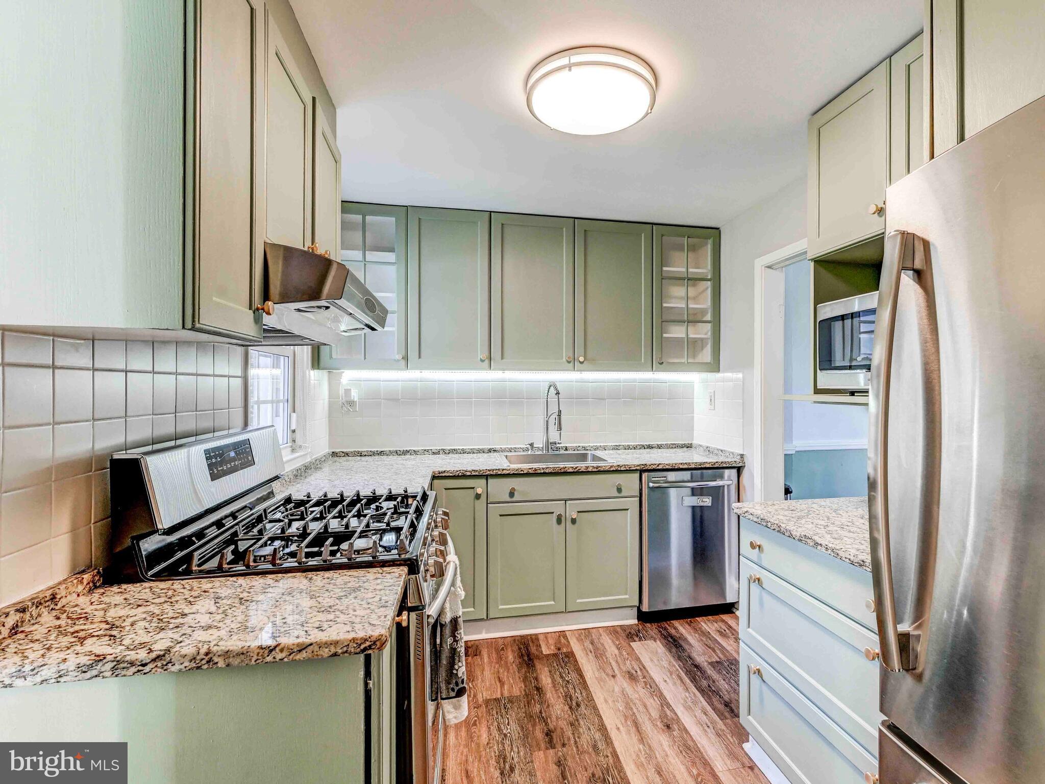 913 Adana Road Baltimore, MD 21208 - Photo 6 of 26 a kitchen with a stove and a sink