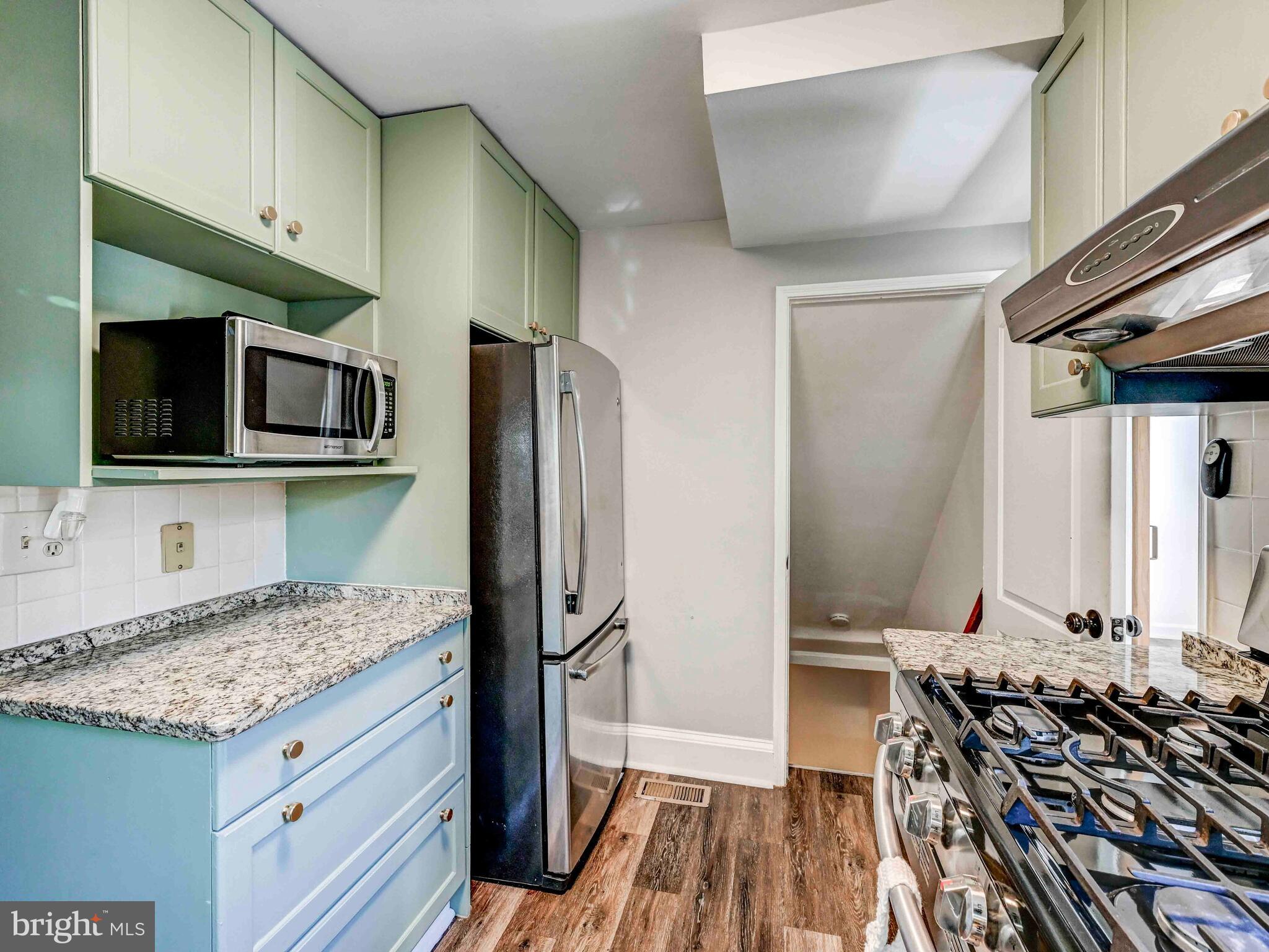 913 Adana Road Baltimore, MD 21208 - Photo 7 of 26 a kitchen with a sink stove and refrigerator