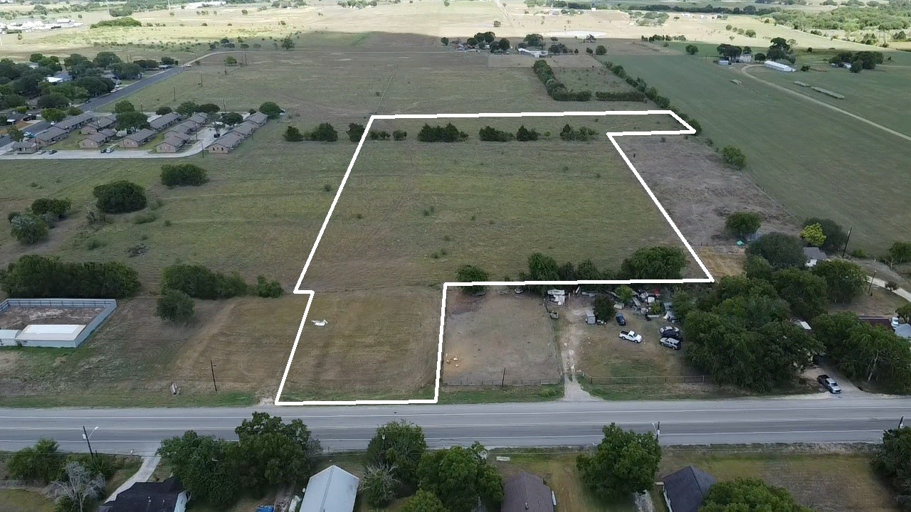 an aerial view of a house with a yard