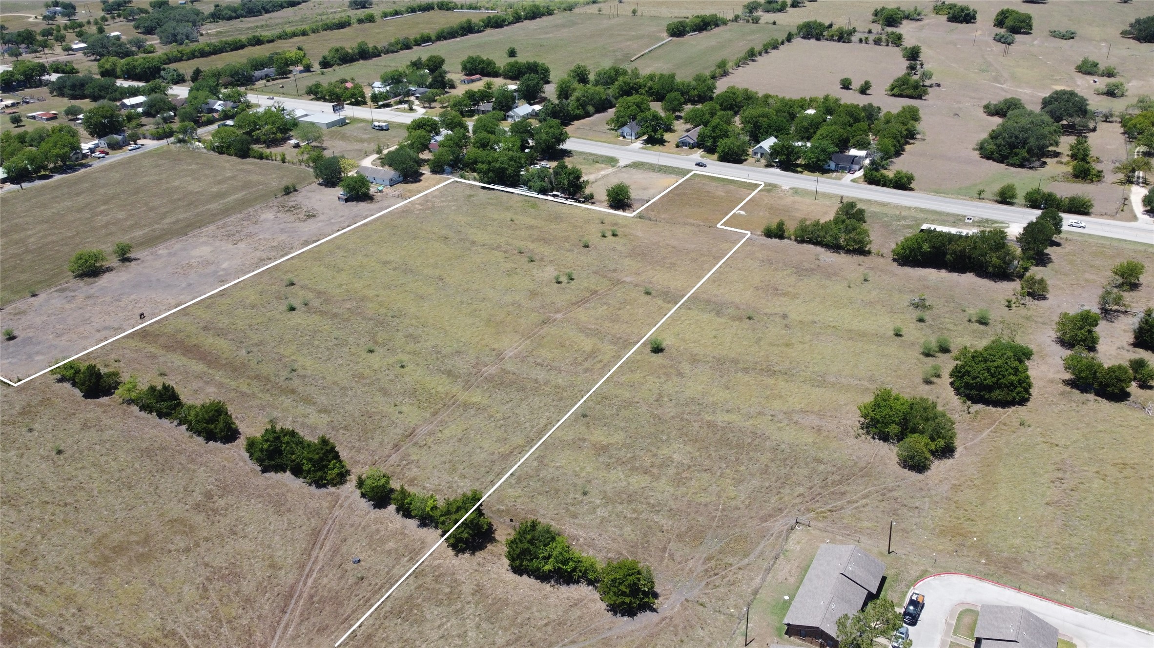 0 Highway 77 Schulenburg, TX 78956 - Photo 10 of 11 an aerial view of a house with a yard and trees