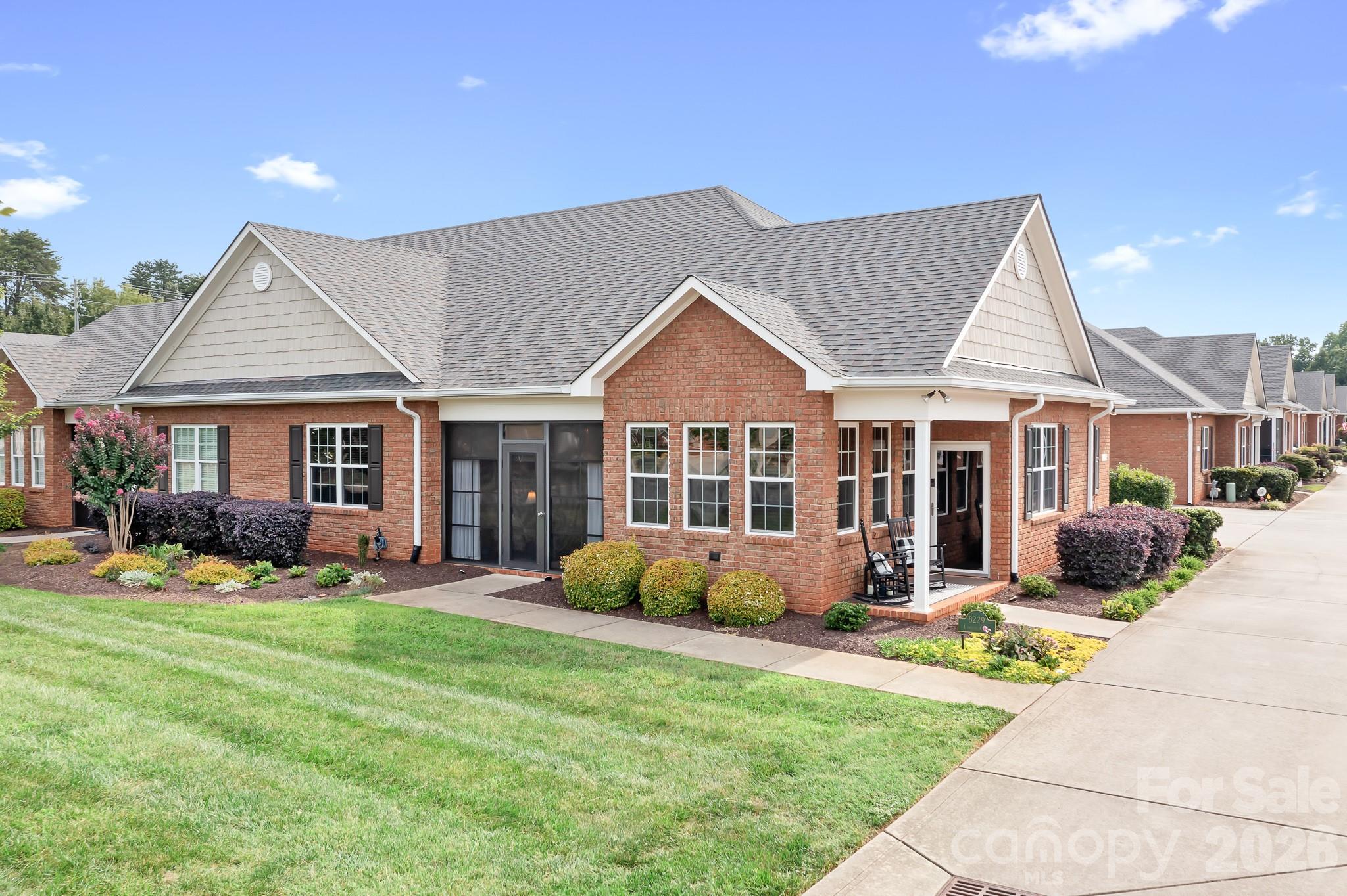 a front view of a house with a yard and porch
