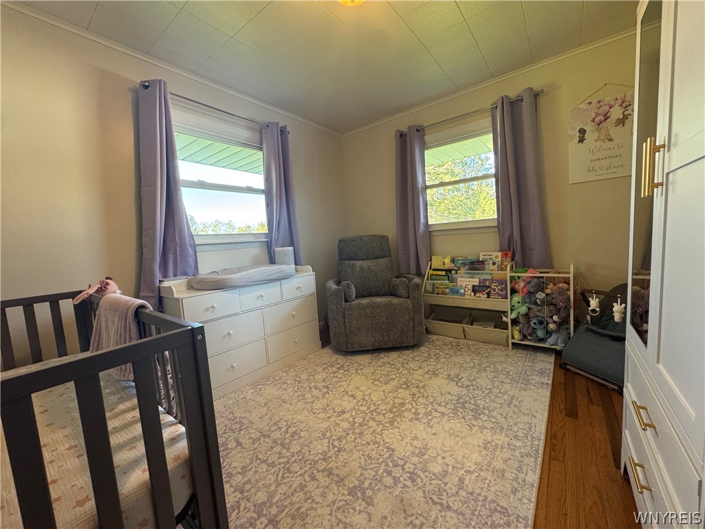10180 Partridge Road Colden, NY 14080 - Photo 17 of 34 Double windows frame this cozy bedroom detailed with classic wood flooring.