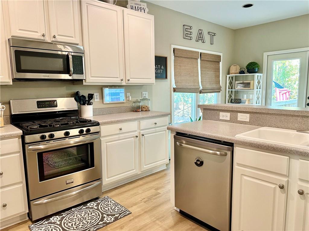 2533 Gold Hill Court Villa Rica, GA 30180 - Photo 12 of 50 a kitchen with stainless steel appliances granite countertop a stove microwave and sink