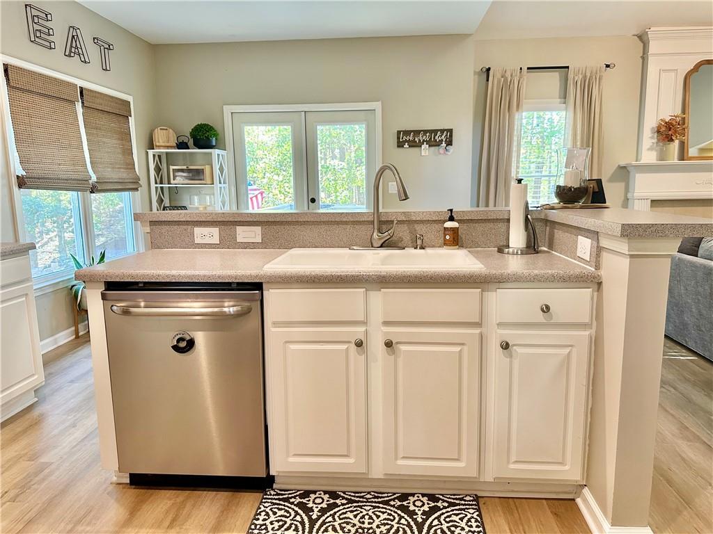 2533 Gold Hill Court Villa Rica, GA 30180 - Photo 13 of 50 a view of kitchen with stainless steel appliances granite countertop a sink and a stove next to a large window